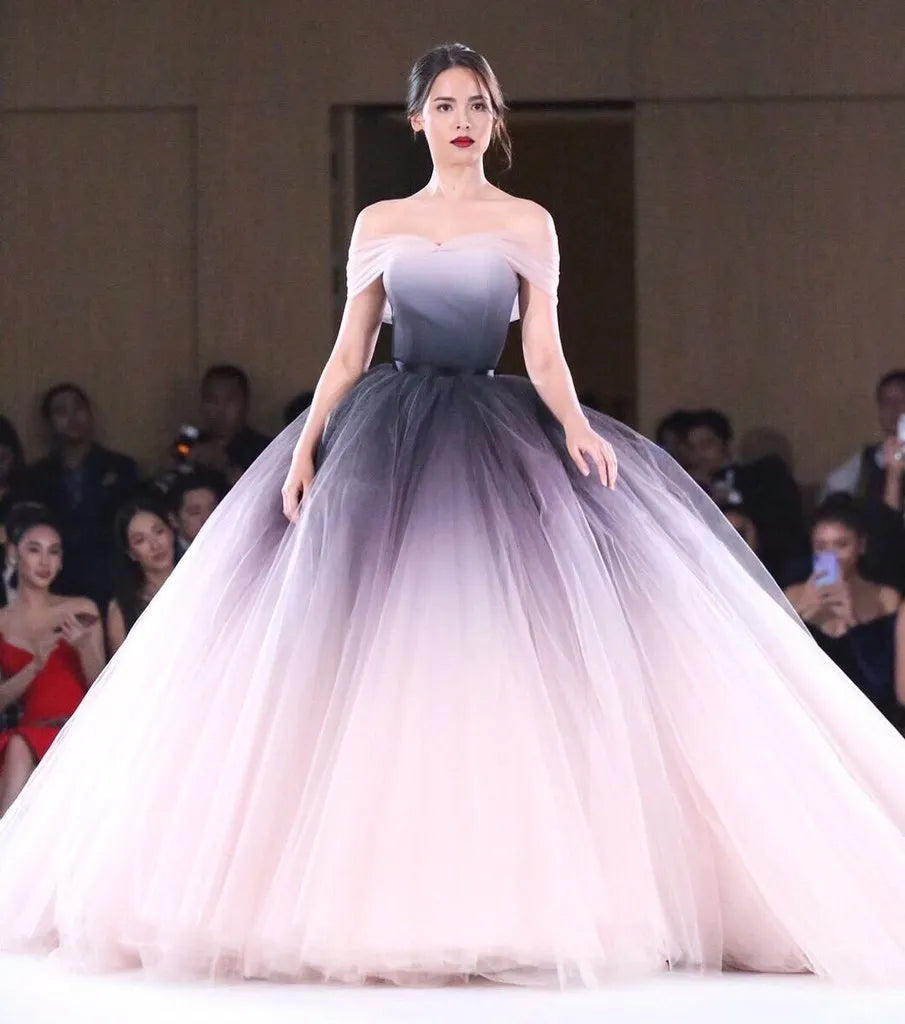 Woman in a strapless, gradient dress on a runway 